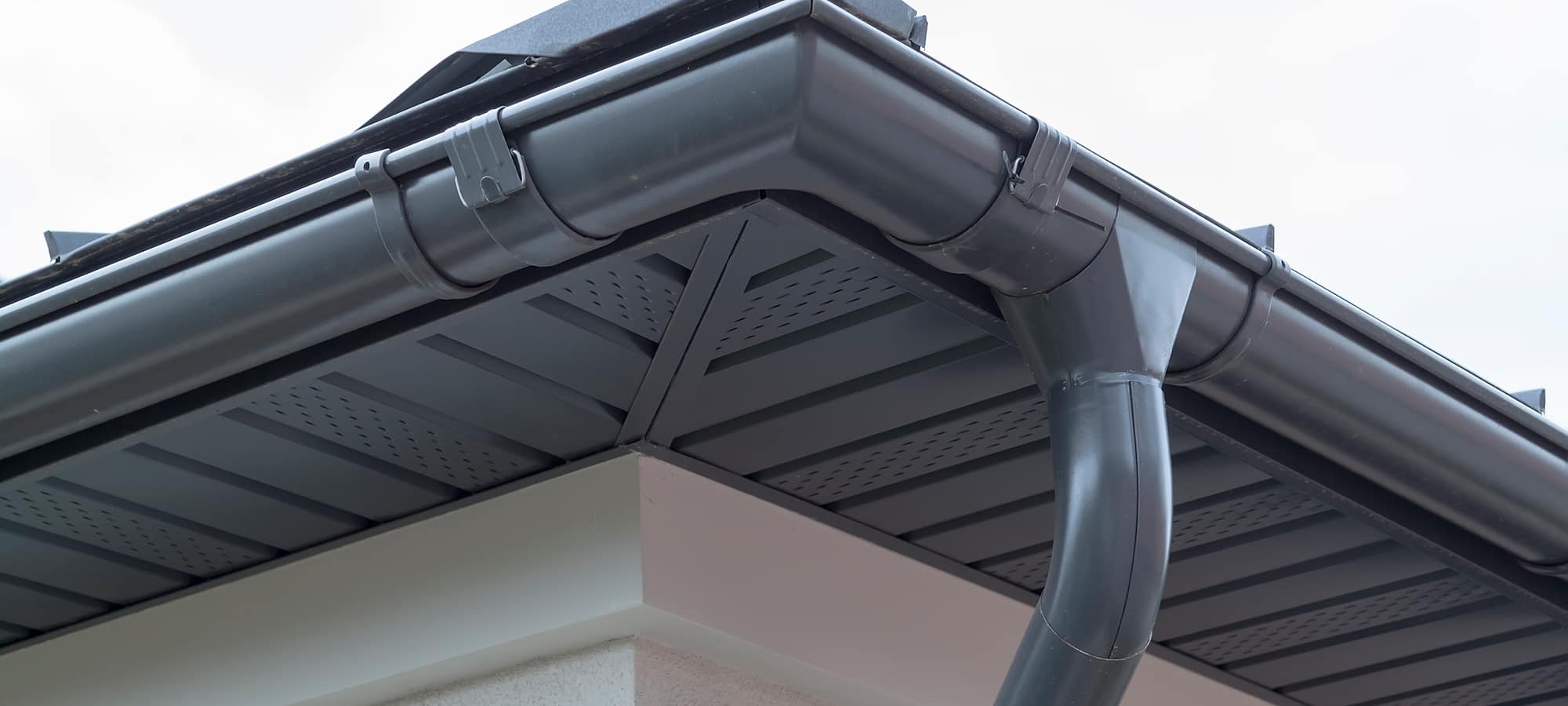 New black guttering and soffits fitted along a roofline