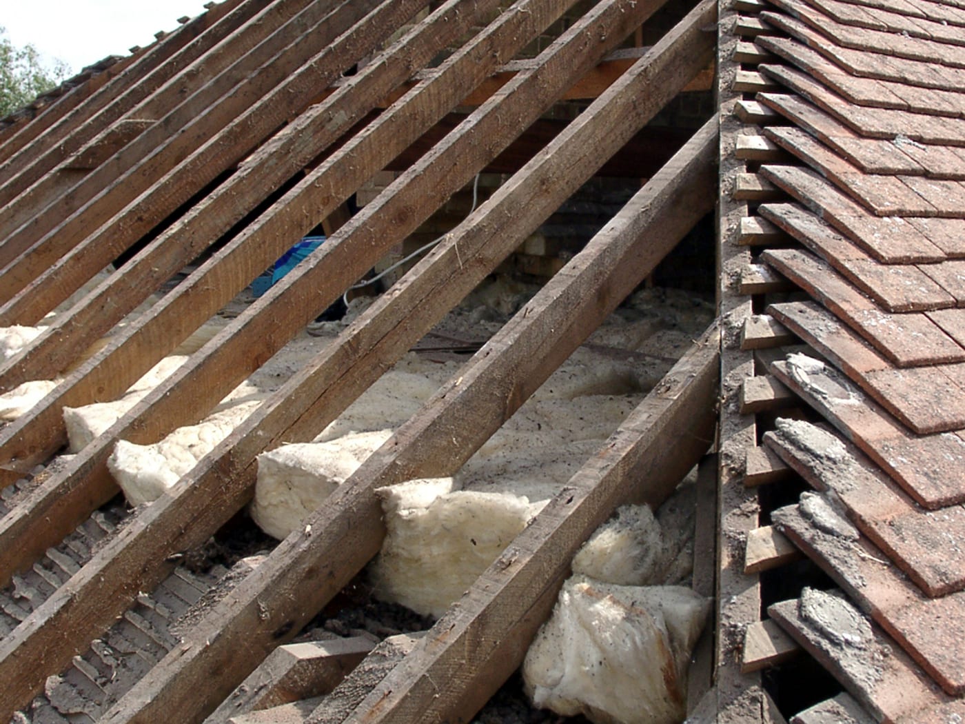 Clay tiles stripped from a roof by storm damage, battens exposed